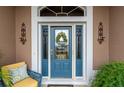 Inviting front entrance with a blue door and sidelights at 3257 Triton Ct, The Villages, FL 32163