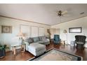 Living room featuring a ceiling fan and wood floors at 3310 Manatee Rd, Tavares, FL 32778