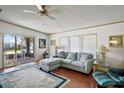 Bright living room with comfy sectional sofa and wood floors at 3310 Manatee Rd, Tavares, FL 32778