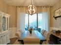 Elegant dining room featuring a large table, chandelier, and view to backyard at 335 Grand Reserve Dr, Davenport, FL 33837