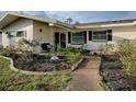 House exterior showcasing a landscaped yard and walkway at 33648 Picciola Dr, Fruitland Park, FL 34731