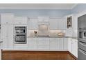 Modern white kitchen with stainless steel appliances at 3545 Lia Ln, The Villages, FL 32163