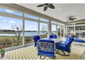 Bright sunroom features large windows with a beautiful view, elegant furniture, and stylish ceiling fans at 3545 Lia Ln, The Villages, FL 32163