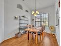 Bright dining room with hardwood floors and a charming window view at 36341 Grand Island Oaks Cir, Grand Island, FL 32735