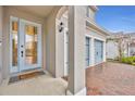 Inviting front entry with a light blue door and brick walkway at 4637 Cragmere Loop, Clermont, FL 34711