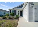 Inviting walkway leads to the front door, complemented by attractive landscaping of this beautiful home at 4654 Ramsell Rd, The Villages, FL 32163