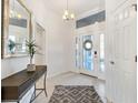 Bright and airy entryway with tile flooring and a console table at 5676 Patterson Loop, The Villages, FL 32163