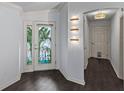 Bright entryway with stained glass door and dark flooring at 583 Arruda Ter, The Villages, FL 32162