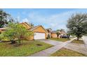 Residential street with well-maintained houses and landscaping at 7872 Niagara Falls Ct, Orlando, FL 32825