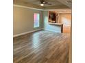 Spacious living room with wood-look tile floors and an open concept design at 827 E Clifford Ave, Eustis, FL 32726