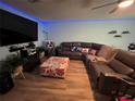 Relaxing living room featuring a large sectional sofa and flat-screen TV at 1017 Willow Dr, Leesburg, FL 34748