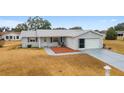 Single-story home, attached garage, and mature landscaping at 10476 Se 178Th St, Summerfield, FL 34491