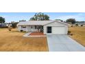 Single story home with attached garage and small front porch at 10476 Se 178Th St, Summerfield, FL 34491
