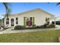 Front view of a single-story home with green shutters at 1220 Maria Ct, Lady Lake, FL 32159