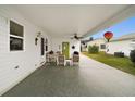 Covered patio with seating area and backyard view at 1220 Maria Ct, Lady Lake, FL 32159