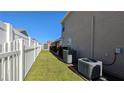 View of backyard with shed, fence, and AC units at 12288 Ne 48Th Loop, Oxford, FL 34484