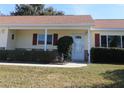 Front entrance of a single-story house with a covered porch and red shutters at 13709 Se 89Th Ave, Summerfield, FL 34491