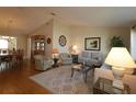 Bright and spacious living room with hardwood floors, neutral color palette, and comfortable seating at 13709 Se 89Th Ave, Summerfield, FL 34491