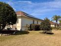 House exterior showcasing solar panels and manicured lawn at 1515 Gadsden Pl, The Villages, FL 32162