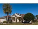 House exterior features a landscaped yard and palm trees at 1515 Gadsden Pl, The Villages, FL 32162