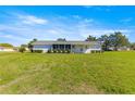 A charming home featuring a well-manicured lawn, and a screened lanai for enjoying the outdoors at 17664 Se 105Th Terrace, Summerfield, FL 34491