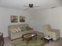 Bright living room featuring a comfy sofa and arm chair at 17664 Se 105Th Terrace, Summerfield, FL 34491