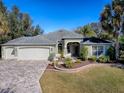 Single-Gathering house with a three car garage and manicured lawn at 17750 Se 86Th Oak Leaf Ter, The Villages, FL 32162