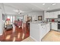 Open kitchen with white cabinets, granite countertops, and hardwood floors at 2005 Palo Alto Ave, The Villages, FL 32159