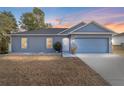 Gray house with a two-car garage at dusk at 2555 Sw 154Th Place Rd, Ocala, FL 34473