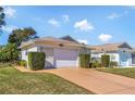Well maintained single Gathering home with attached garage and neat landscaping at 26607 Racquet Cir, Leesburg, FL 34748
