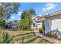 Landscaped pathway leading to the entrance of a charming house at 26607 Racquet Cir, Leesburg, FL 34748