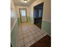 Bright entryway with light green walls and tiled flooring at 29 Lonesome Pine Trl, Yalaha, FL 34797
