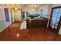 Eat-in kitchen with wood-look flooring and ample cabinet space at 29 Lonesome Pine Trl, Yalaha, FL 34797
