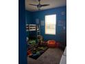 Blue-walled bedroom with a bunk bed, dresser, and a beanbag chair at 37030 Lake Overlook Dr, Grand Island, FL 32735