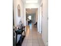 A long hallway entryway with a console table and views to the kitchen and dining area at 37030 Lake Overlook Dr, Grand Island, FL 32735