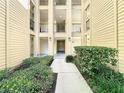 Condo building interior walkway with lush green landscaping on either side at 413 Summit Ridge Pl # 201, Longwood, FL 32779