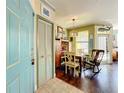 Bright dining area with hardwood floors, a rocking chair and an entryway at 413 Summit Ridge Pl # 201, Longwood, FL 32779