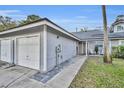 Gray house exterior with two-car garage and walkway at 4544 Summergrove Ave, Orlando, FL 32812