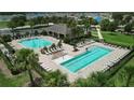 Community pool area with lap lanes, lounge chairs, and a covered pavilion at 5756 Lakeside Landings Blvd, Winter Haven, FL 33881
