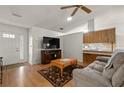 Living room features hardwood floors and open concept to kitchen at 610 Fannich Ct, Leesburg, FL 34788