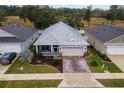 Single-story house with metal roof, screened porch, and landscaped yard at 6342 Sanders Grove Cir, Okahumpka, FL 34762