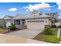 Lovely single-story home featuring a brick-paved driveway, two-car garage, and cozy screened porch at 6342 Sanders Grove Cir, Okahumpka, FL 34762