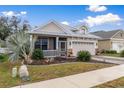 One-story home with metal roof, screened porch, and landscaped yard at 6342 Sanders Grove Cir, Okahumpka, FL 34762