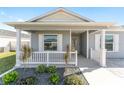 White porch with gray house siding and landscaping at 6764 Mary Loop, The Villages, FL 34762