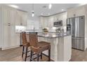 Updated kitchen with island, stainless steel appliances, and white cabinets at 10406 Lakeshore Dr, Clermont, FL 34711