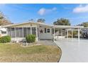 Cute and cozy single-wide home with carport and nicely landscaped yard at 11 Orangewood Dr, Fruitland Park, FL 34731