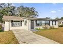 One story house with a large front yard and driveway at 1412 N Garfield Ave, Deland, FL 32724
