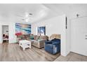 Living room with gray sectional sofa, white coffee table, and ocean wall art at 1412 N Garfield Ave, Deland, FL 32724