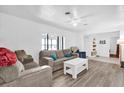 Living room with gray sofas, white coffee table, and wood-look flooring at 1412 N Garfield Ave, Deland, FL 32724