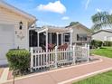 Relaxing patio area with pergola, table and chairs, perfect for outdoor dining at 17744 Se 95Th Ct, Summerfield, FL 34491